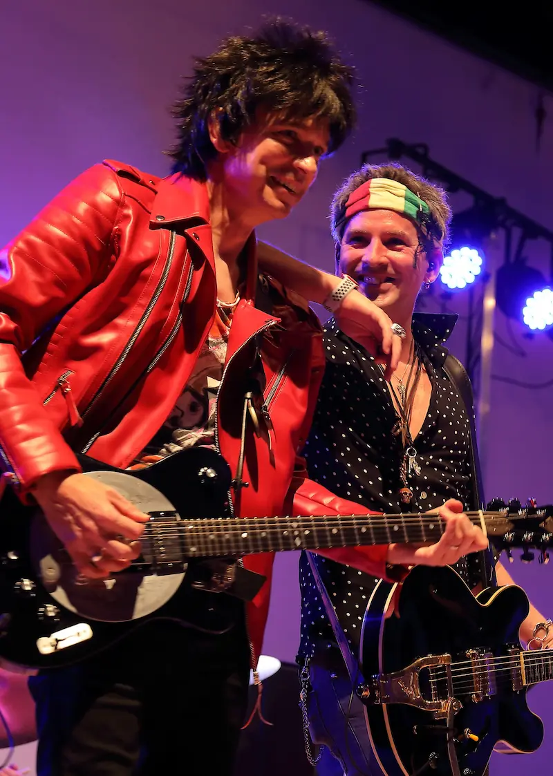 The Rolling Clones guitarists on stage at a theatre show