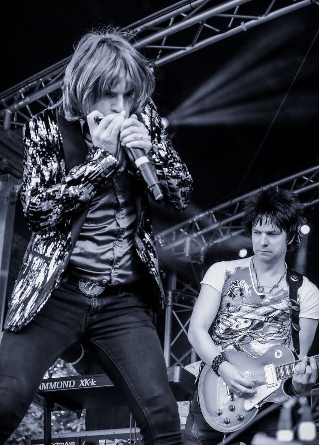 The Rolling Clones on a festival stage with a packed crowd